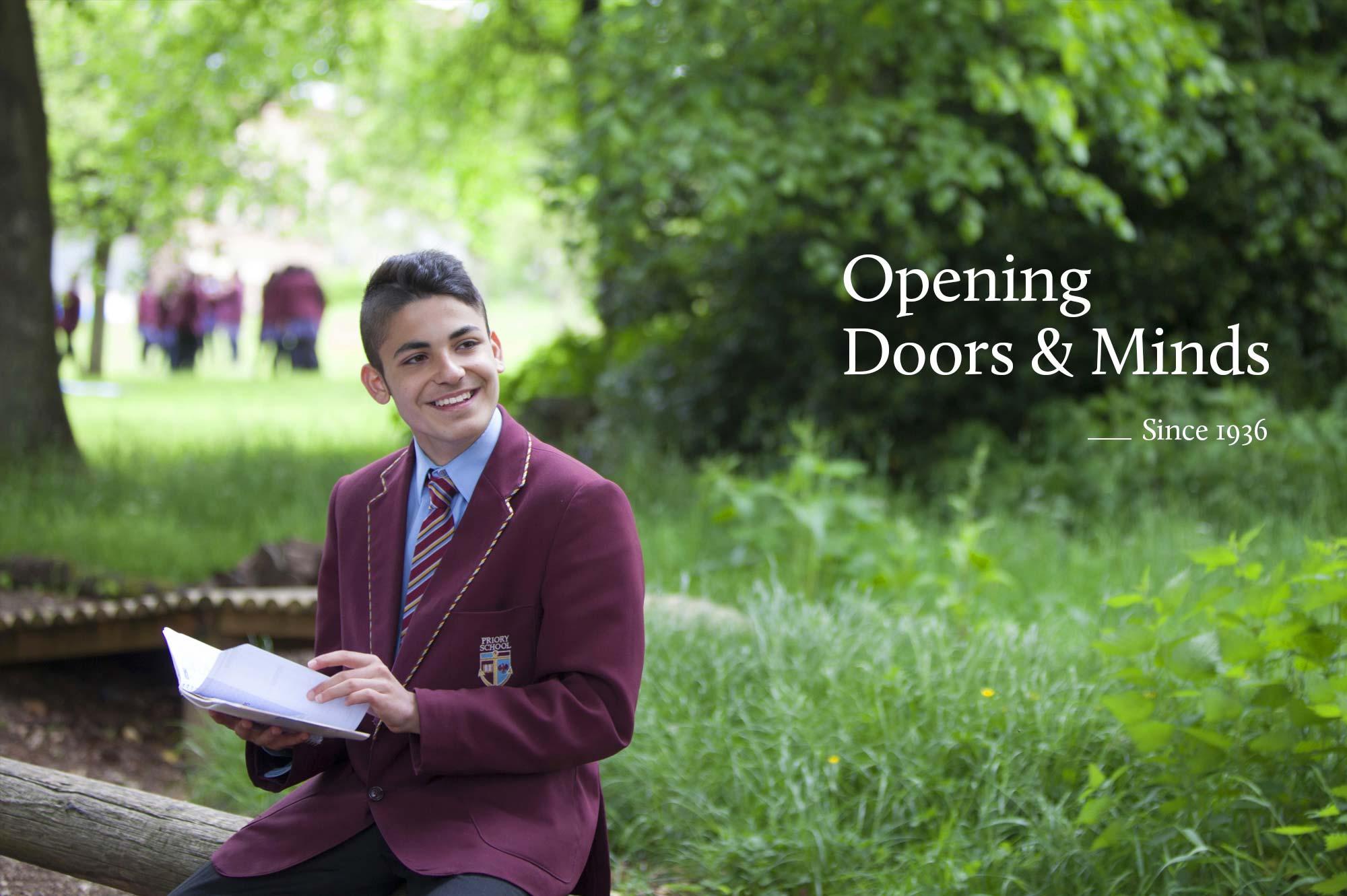 Priory School pupil sitting outside reading